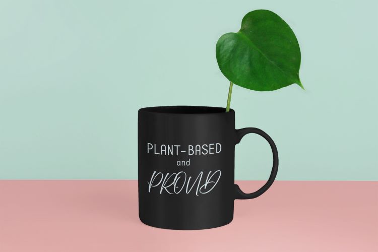 Glossy mug with 'Plant-Based and Proud' slogan promoting a meat-free lifestyle