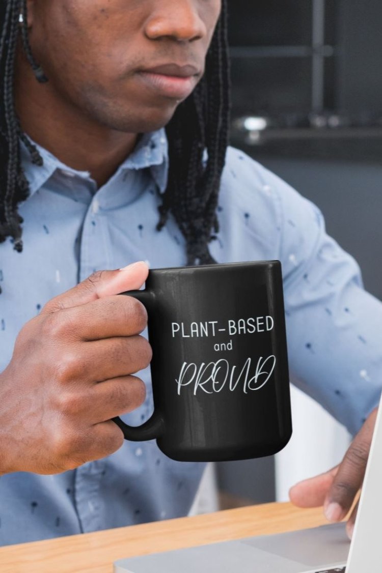 Glossy mug with 'Plant-Based and Proud' slogan promoting a meat-free lifestyle