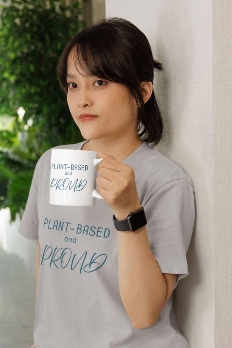 Glossy mug with 'Plant-Based and Proud' slogan promoting a meat-free lifestyle