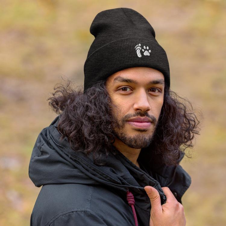 Cuffed beanie with human foot and animal paw embroidery symbolizing unity