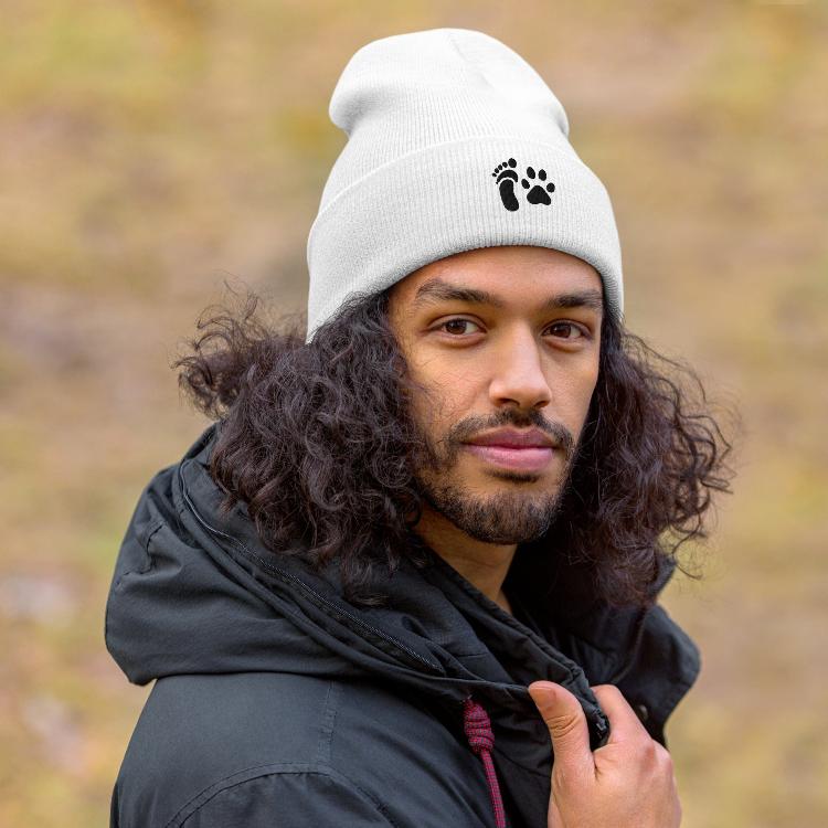 Cuffed beanie featuring human foot and animal paw embroidery for unity