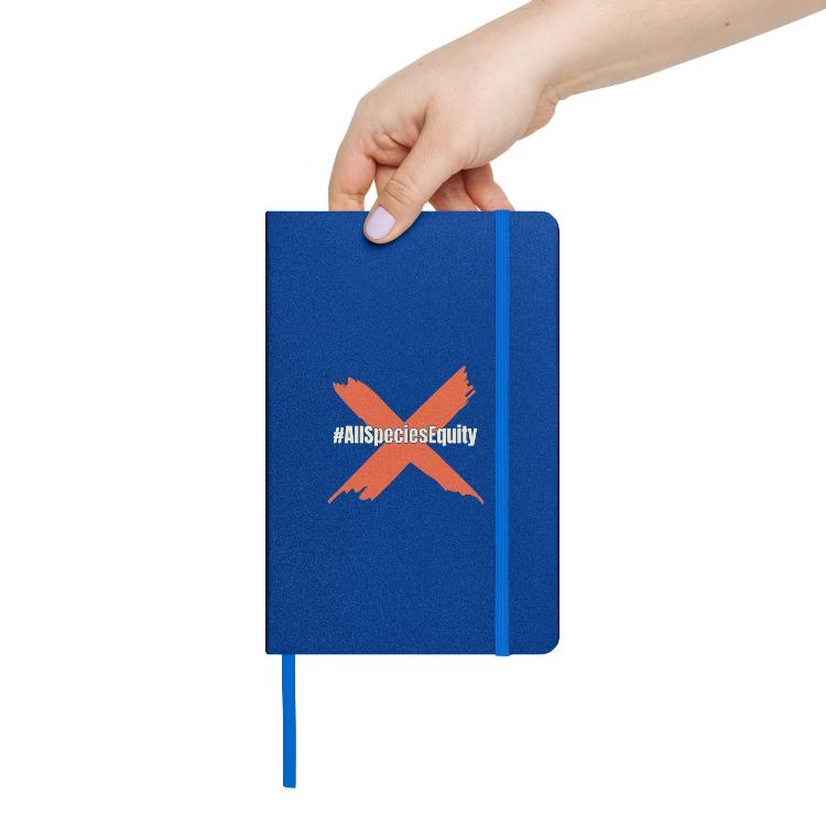 Vegetizer Hardcover Bound Notebook featuring campaign symbol and hashtag #AllSpeciesEquity, 80 lined cream-colored pages, elastic closure, ribbon marker, expandable inner pocket, eco-friendly design