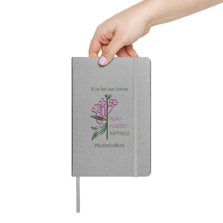 Vegetizer Hardcover Notebook with 'Plant-Powered Happiness' message, 80 lined cream-colored pages, elastic closure, ribbon marker, expandable inner pocket, eco-friendly design, promoting plant-based lifestyle