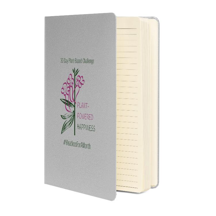 Vegetizer Hardcover Notebook with 'Plant-Powered Happiness' message, 80 lined cream-colored pages, elastic closure, ribbon marker, expandable inner pocket, eco-friendly design, promoting plant-based lifestyle