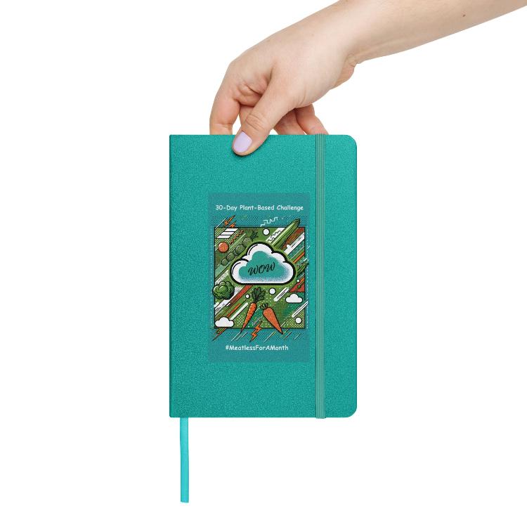 Eco-friendly notebook, vibrant pop art design, bright green, turquoise, orange vegetables, 30-Day Plant-Based Challenge, sustainable living, animal rights, cream-colored lined pages, elastic closure, ribbon marker