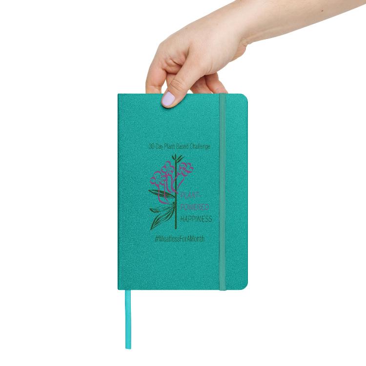 Vegetizer Hardcover Notebook with 'Plant-Powered Happiness' message, 80 lined cream-colored pages, elastic closure, ribbon marker, expandable inner pocket, eco-friendly design, promoting plant-based lifestyle