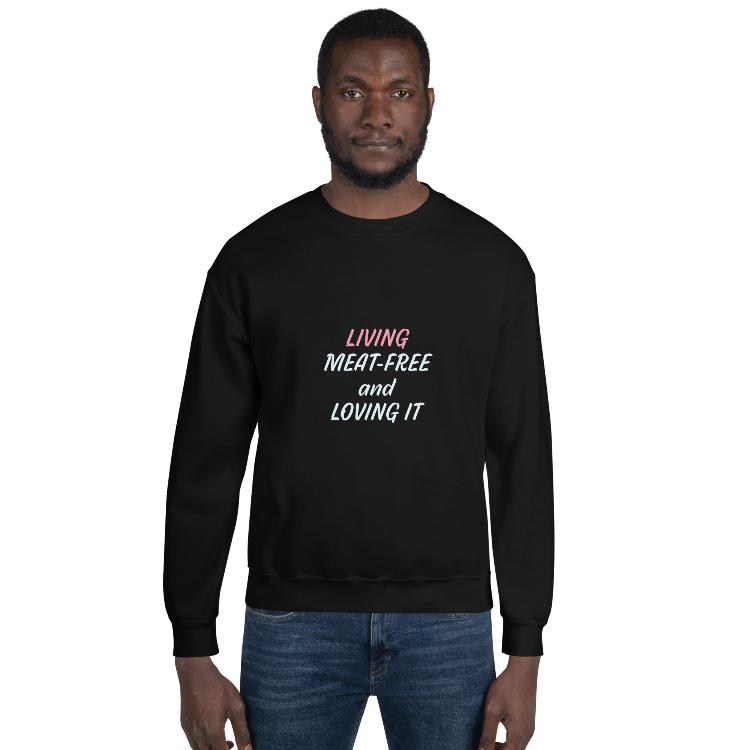 Sweatshirt featuring the slogan 'Living Meat-Free and Loving It', with human foot and animal paw prints on the label. Promotes a plant-based lifestyle and awareness for animal welfare