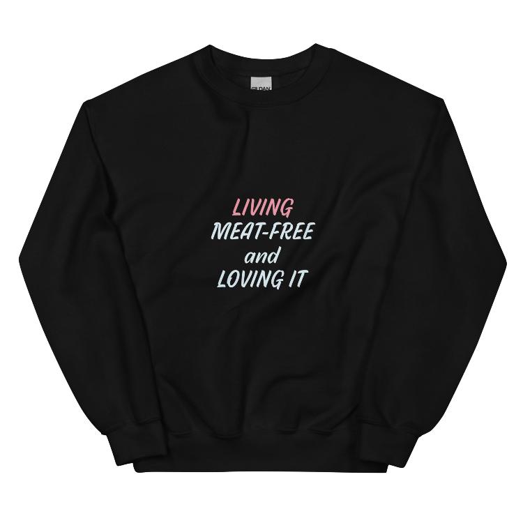 Sweatshirt featuring the slogan 'Living Meat-Free and Loving It', with human foot and animal paw prints on the label. Promotes a plant-based lifestyle and awareness for animal welfare