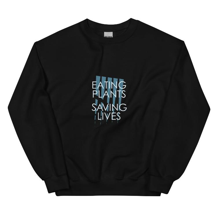 Cozy plant-based sweatshirt with the slogan 'Eating Plants, Saving Lives' on the front, featuring a label with human foot and animal paw prints, promoting animal welfare and a meat-free lifestyle