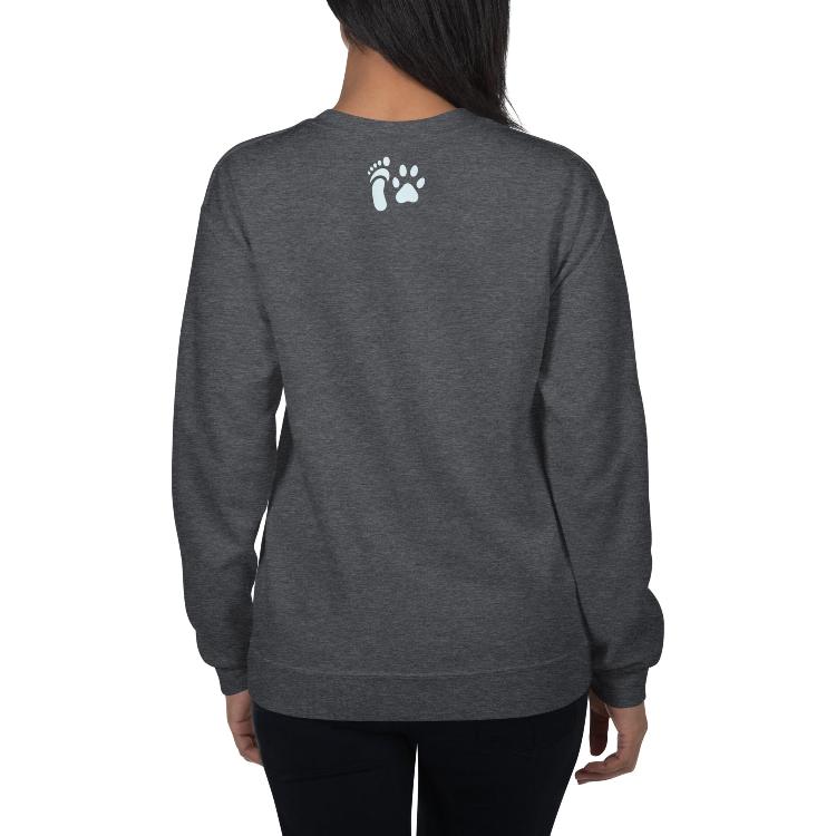 Sweatshirt featuring the slogan 'Living Meat-Free and Loving It', with human foot and animal paw prints on the label. Promotes a plant-based lifestyle and awareness for animal welfare