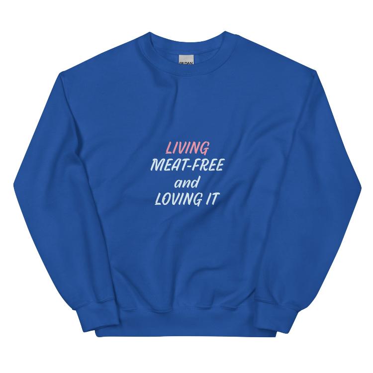 Sweatshirt featuring the slogan 'Living Meat-Free and Loving It', with human foot and animal paw prints on the label. Promotes a plant-based lifestyle and awareness for animal welfare