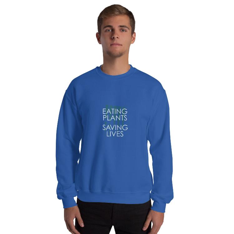 Cozy plant-based sweatshirt with the slogan 'Eating Plants, Saving Lives' on the front, featuring a label with human foot and animal paw prints, promoting animal welfare and a meat-free lifestyle