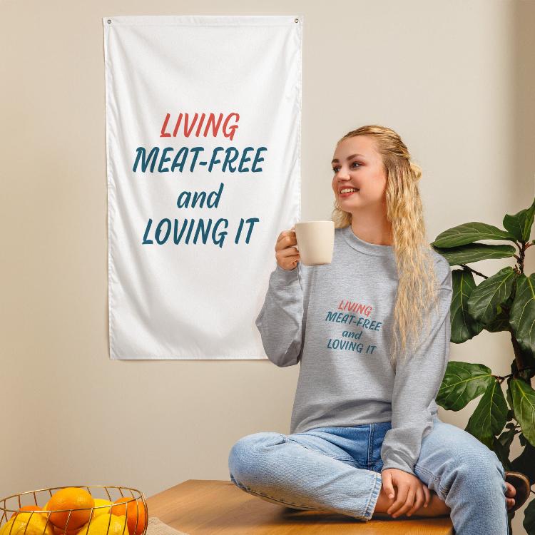 Comfortable plant-based sweatshirt with the slogan 'Living Meat-Free and Loving It'. Features human foot and animal paw prints symbolizing harmony. Ideal for promoting a plant-based lifestyle and animal welfare awareness