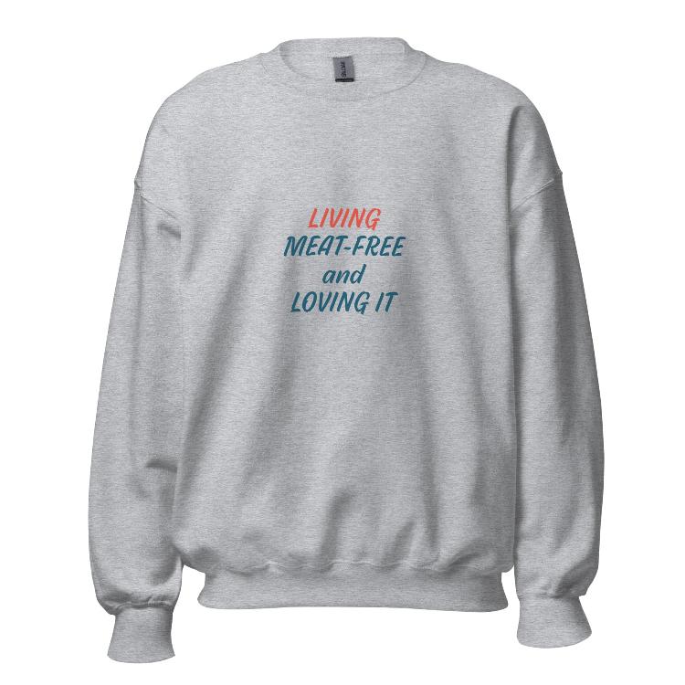 Comfortable plant-based sweatshirt with the slogan 'Living Meat-Free and Loving It'. Features human foot and animal paw prints symbolizing harmony. Ideal for promoting a plant-based lifestyle and animal welfare awareness