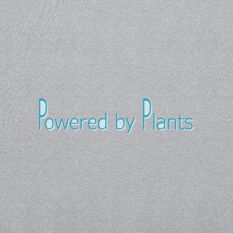 Comfortable sweatshirt with the slogan 'Powered by Plants' on the front, featuring a label with human footprint and animal paw prints, symbolizing harmony between humans and animals, promoting a plant-based lifestyle and animal welfare