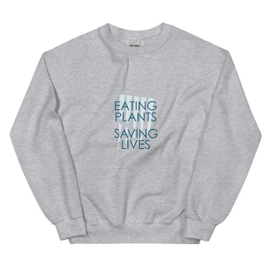 Cozy plant-based sweatshirt featuring the slogan 'Eating Plants, Saving Lives' on the front, with human foot and animal paw prints on the label, promoting the 30-Day Plant-Based Challenge and raising awareness for animal welfare