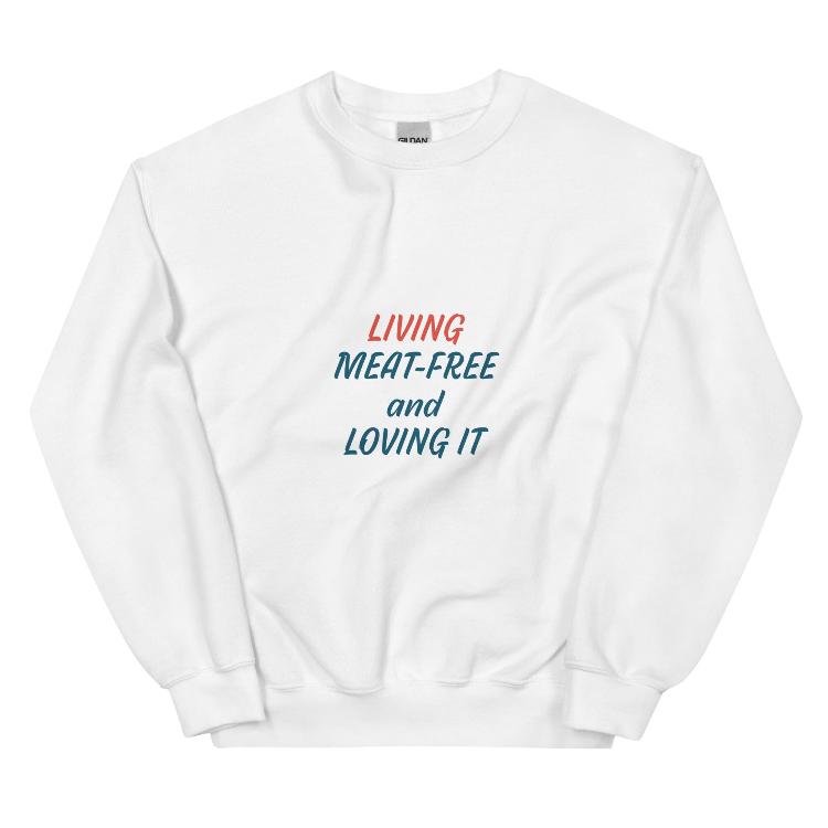 Comfortable plant-based sweatshirt with the slogan 'Living Meat-Free and Loving It'. Features human foot and animal paw prints symbolizing harmony. Ideal for promoting a plant-based lifestyle and animal welfare awareness