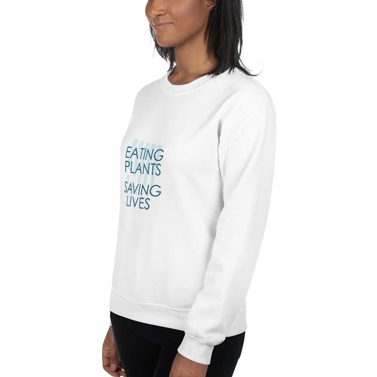 Cozy plant-based sweatshirt featuring the slogan 'Eating Plants, Saving Lives' on the front, with human foot and animal paw prints on the label, promoting the 30-Day Plant-Based Challenge and raising awareness for animal welfare