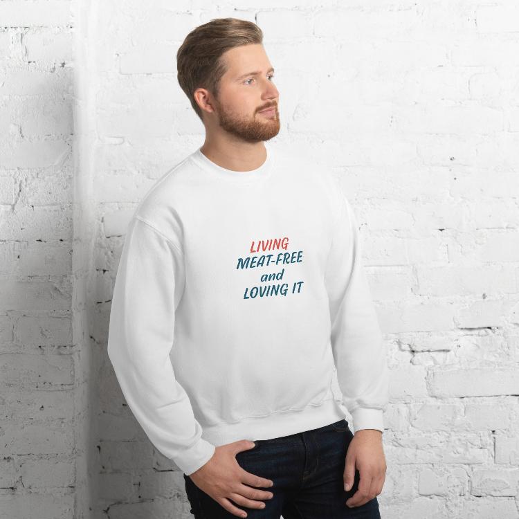 Comfortable plant-based sweatshirt with the slogan 'Living Meat-Free and Loving It'. Features human foot and animal paw prints symbolizing harmony. Ideal for promoting a plant-based lifestyle and animal welfare awareness