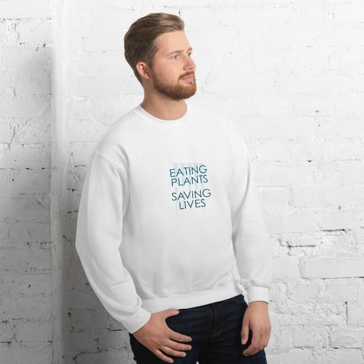 Cozy plant-based sweatshirt featuring the slogan 'Eating Plants, Saving Lives' on the front, with human foot and animal paw prints on the label, promoting the 30-Day Plant-Based Challenge and raising awareness for animal welfare