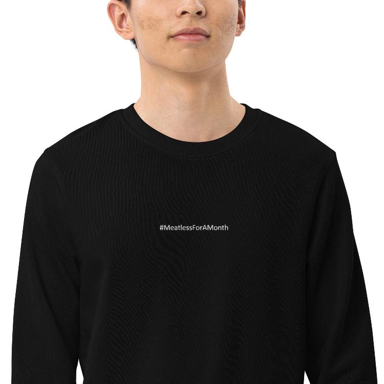 Organic unisex sweatshirt with #MeatlessForAMonth chest embroidery, human foot and animal paw design on right wrist, eco-friendly, made from organic cotton and recycled polyester, promotes plant-based lifestyle, animal rights, and sustainability