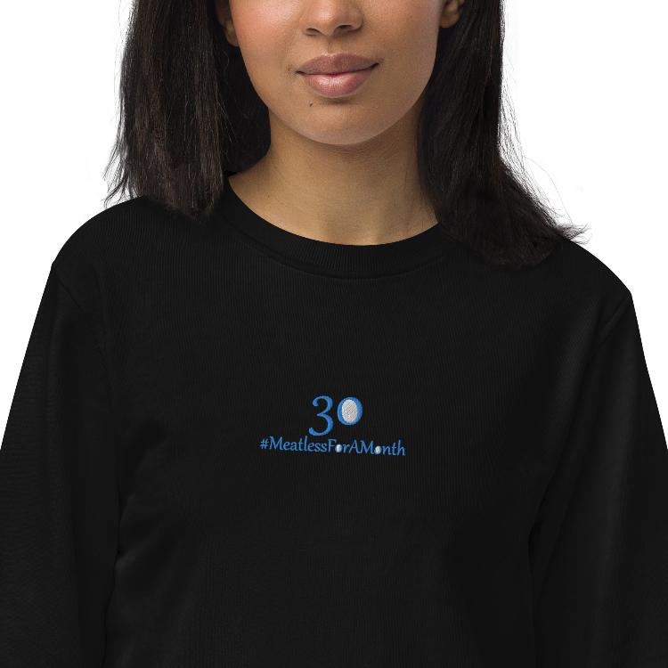 Organic unisex sweatshirt with #MeatlessForAMonth chest embroidery, human foot and animal paw design, eco-friendly, soft fabric, made from organic cotton and recycled polyester, promotes plant-based lifestyle and animal welfare.