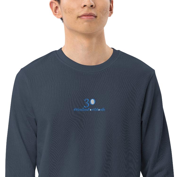 Organic unisex sweatshirt with #MeatlessForAMonth chest embroidery, human foot and animal paw design, eco-friendly, soft fabric, made from organic cotton and recycled polyester, promotes plant-based lifestyle and animal welfare.