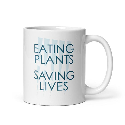 Glossy mug with "Eating Plants, Saving Lives" slogan for plant-based advocacy