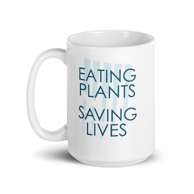 Glossy mug with "Eating Plants, Saving Lives" slogan for plant-based advocacy